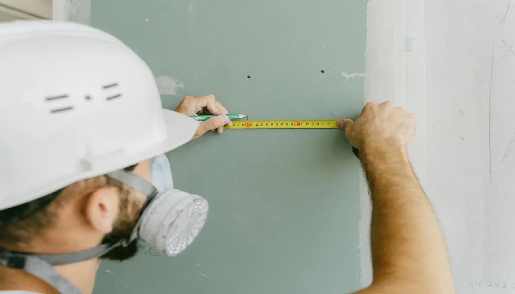 Measuring a jobsite with a mask on